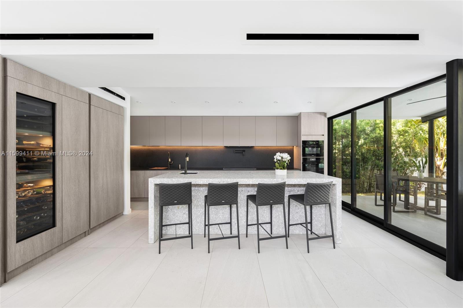 5225 La Gorce Drive Miami Beach, FL 33140 - Photo 25 of 64 a dining room with furniture and a floor to ceiling window