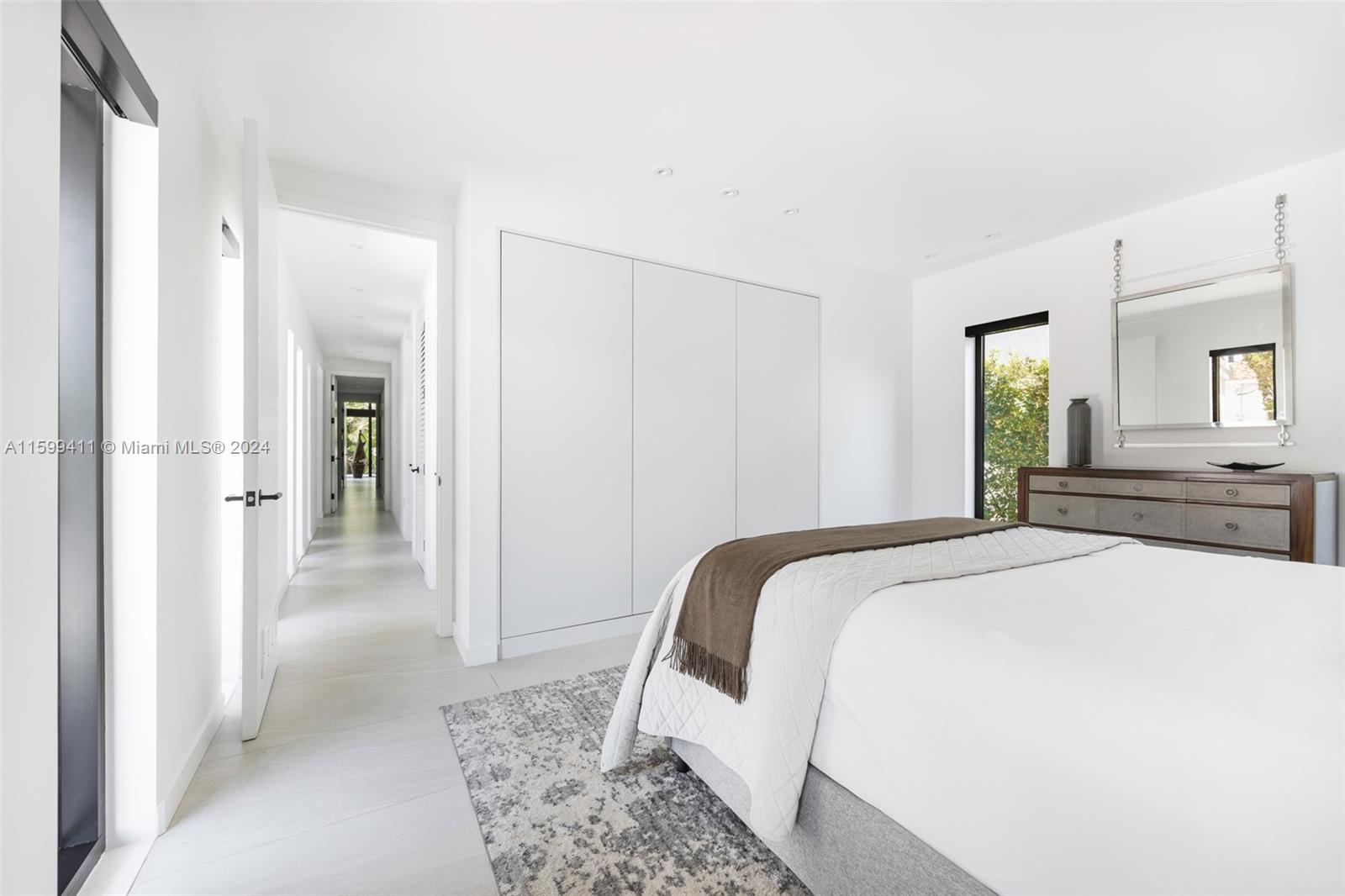 5225 La Gorce Drive Miami Beach, FL 33140 - Photo 28 of 64 a spacious bedroom with a bed and a couch