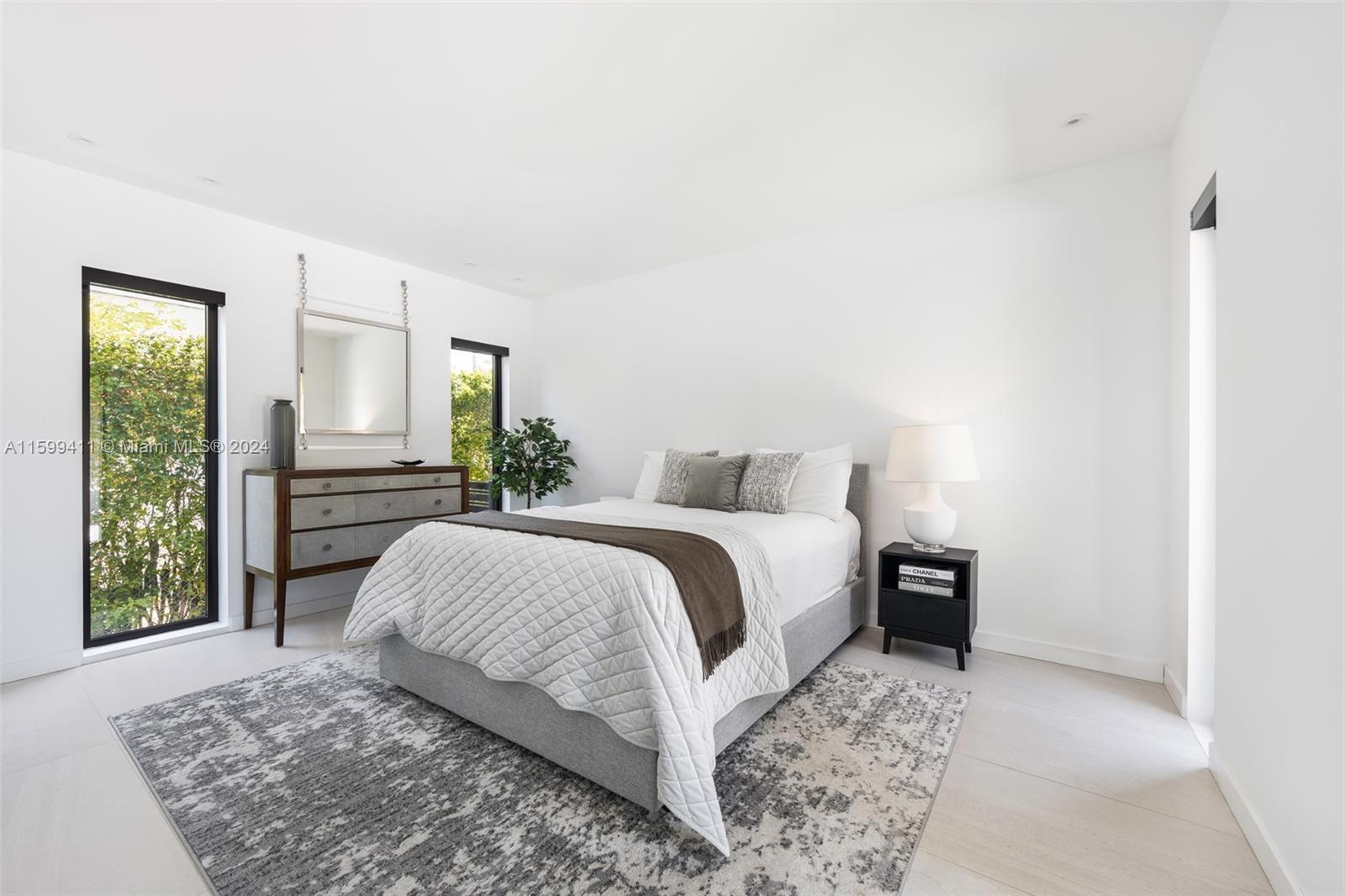 5225 La Gorce Drive Miami Beach, FL 33140 - Photo 29 of 64 a bedroom with a large bed and a window