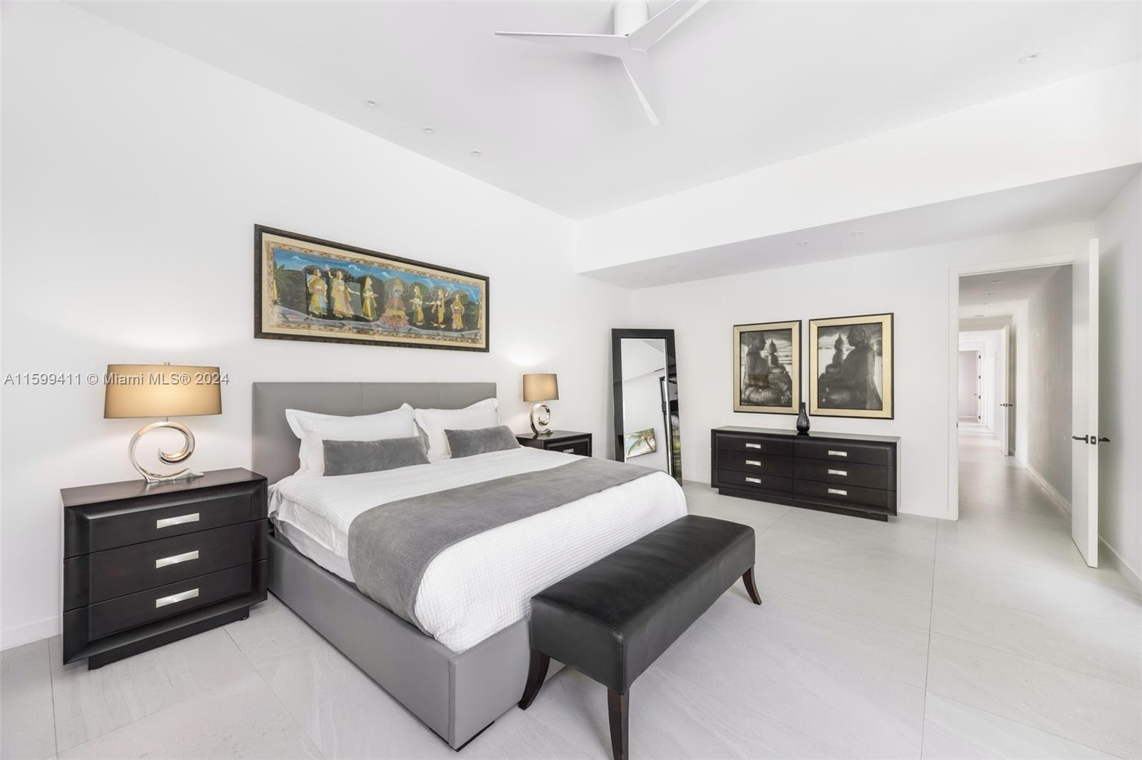 5225 La Gorce Drive Miami Beach, FL 33140 - Photo 30 of 64 a spacious bedroom with a bed a couch and dresser