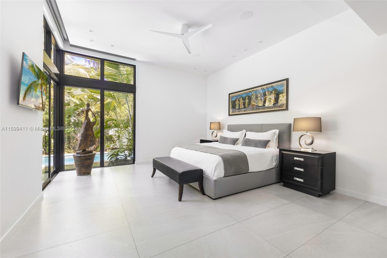 5225 La Gorce Drive Miami Beach, FL 33140 - Photo 31 of 64 a spacious bedroom with a bed and a large window