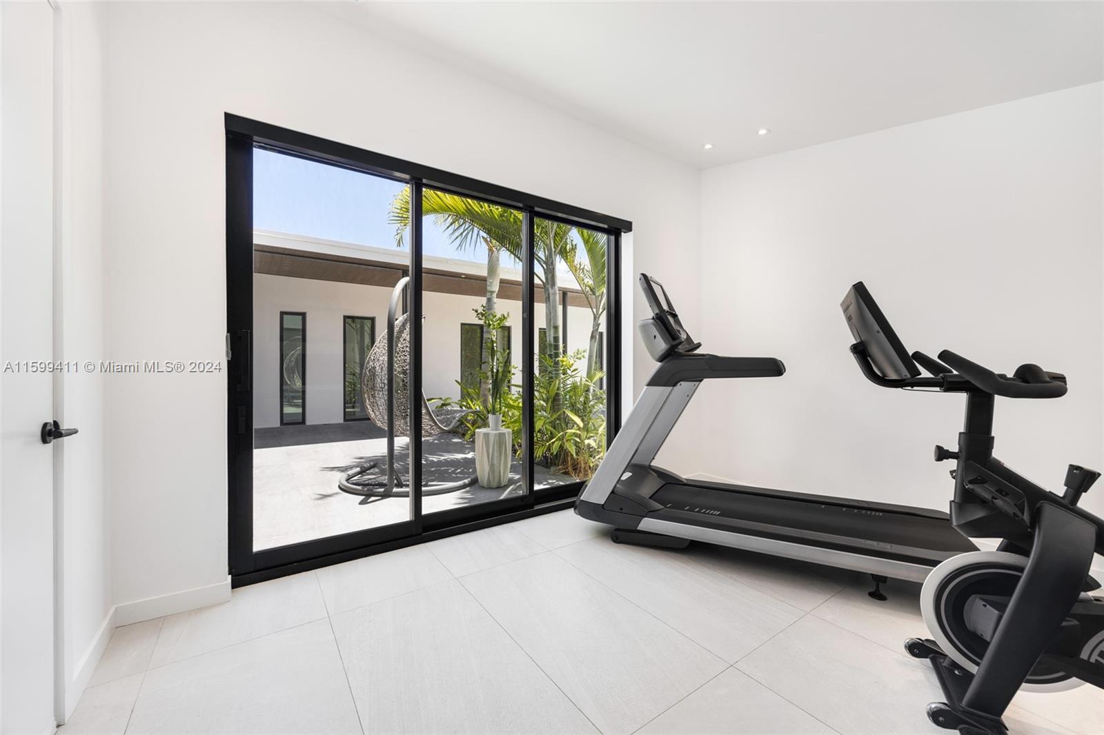 5225 La Gorce Drive Miami Beach, FL 33140 - Photo 34 of 64 a room with gym equipment and large window