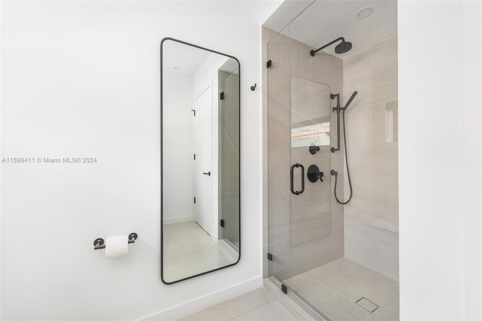 5225 La Gorce Drive Miami Beach, FL 33140 - Photo 39 of 64 a bathroom with a glass shower door
