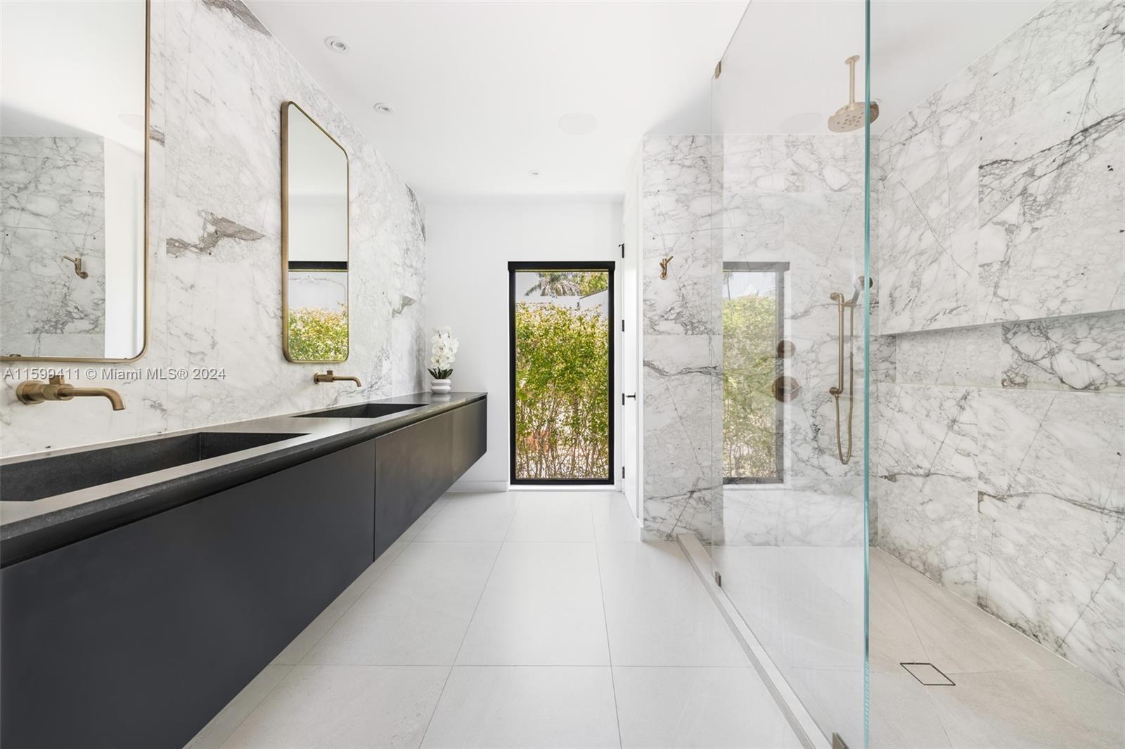 5225 La Gorce Drive Miami Beach, FL 33140 - Photo 41 of 64 a large bathroom with a bathtub and a double vanity sink a mirror