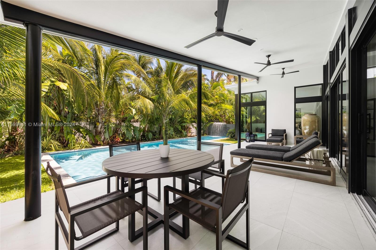 5225 La Gorce Drive Miami Beach, FL 33140 - Photo 45 of 64 a view of a dining room with furniture and a floor to ceiling window