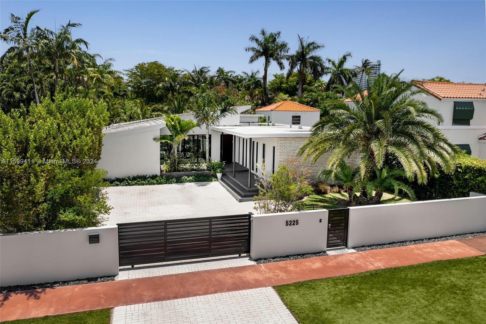 5225 La Gorce Drive Miami Beach, FL 33140 - Photo 56 of 64 a view of a white house with a yard and a sitting area