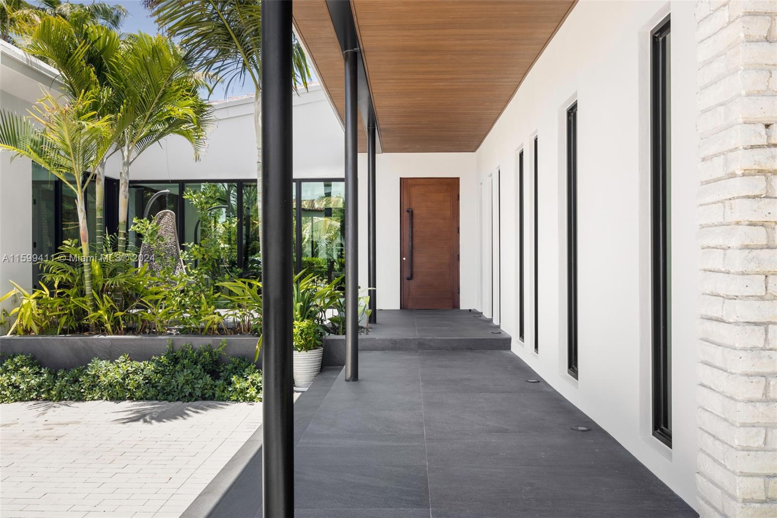 5225 La Gorce Drive Miami Beach, FL 33140 - Photo 8 of 64 a view of a house with a yard and potted plants