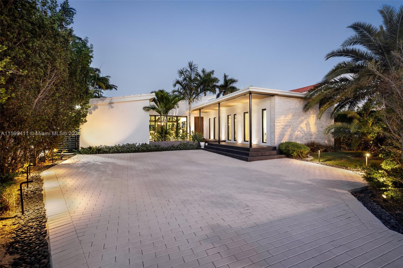 5225 La Gorce Drive Miami Beach, FL 33140 - Photo 9 of 64 a front view of a house with a yard and garage