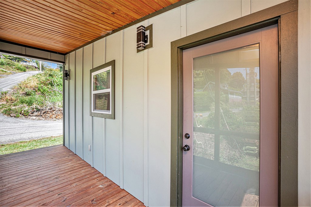 177 Main Street Copperhill, TN 37317 - Photo 19 of 26 a view of a porch with wooden floor and front door