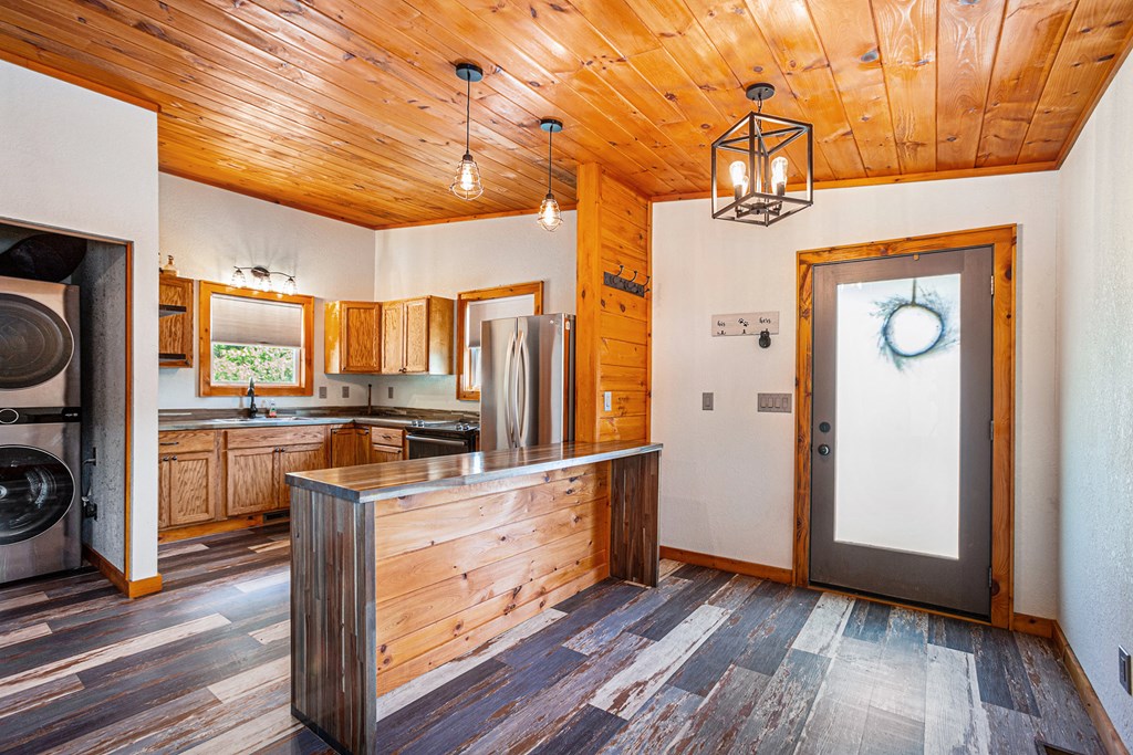 177 Main Street Copperhill, TN 37317 - Photo 3 of 26 a kitchen with stainless steel appliances granite countertop a refrigerator a stove and a wooden floors