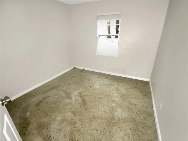 an empty room with a windows