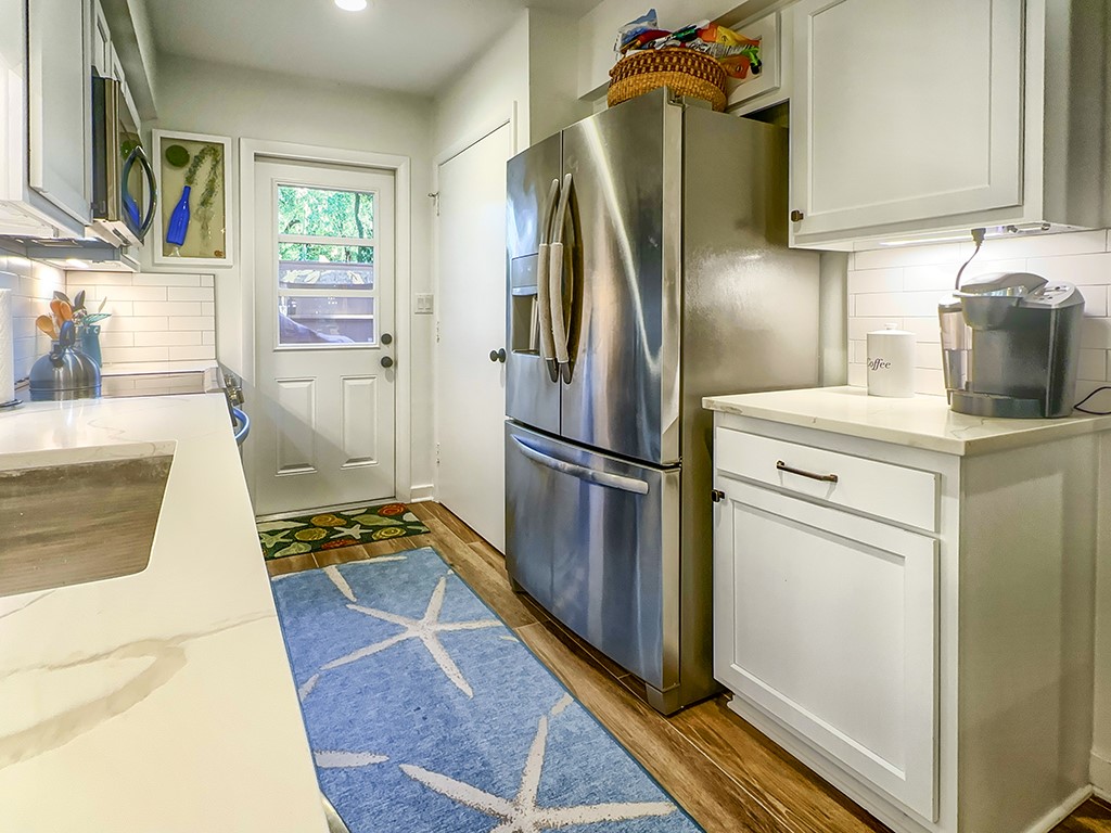 3211 Sea Marsh Road Fernandina Beach, FL 32034 - Photo 11 of 30 a kitchen with stainless steel appliances granite countertop a refrigerator and a stove