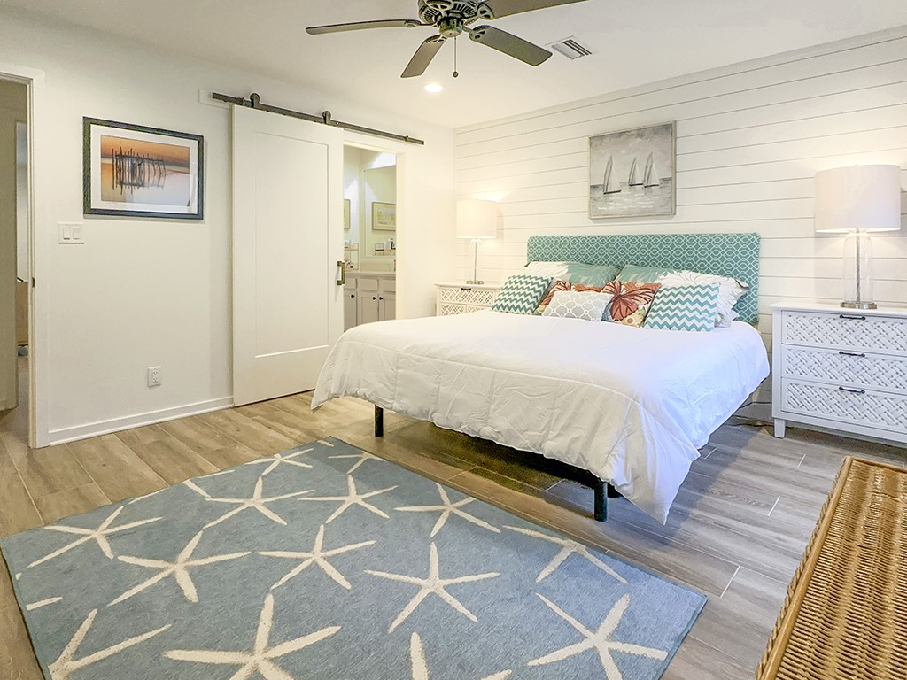 3211 Sea Marsh Road Fernandina Beach, FL 32034 - Photo 13 of 30 a bedroom with a bed and a chandelier