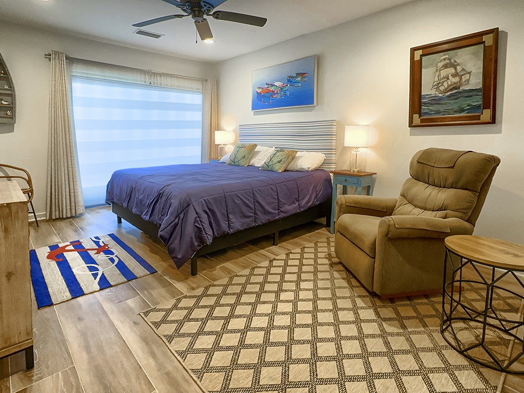 3211 Sea Marsh Road Fernandina Beach, FL 32034 - Photo 18 of 30 a bedroom with a bed and a couch
