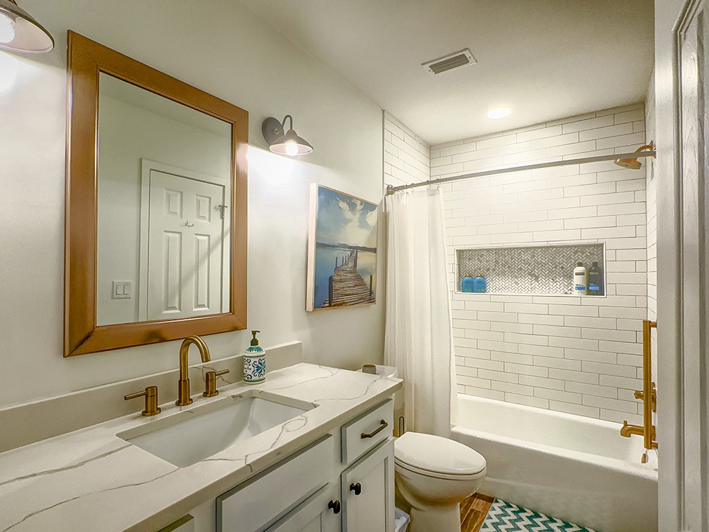 3211 Sea Marsh Road Fernandina Beach, FL 32034 - Photo 21 of 30 a bathroom with a sink a toilet and shower