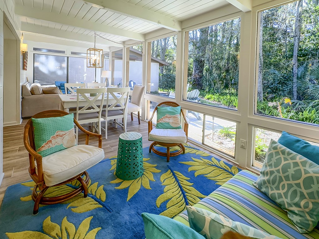 3211 Sea Marsh Road Fernandina Beach, FL 32034 - Photo 22 of 30 a living room filled with furniture and floor to ceiling windows