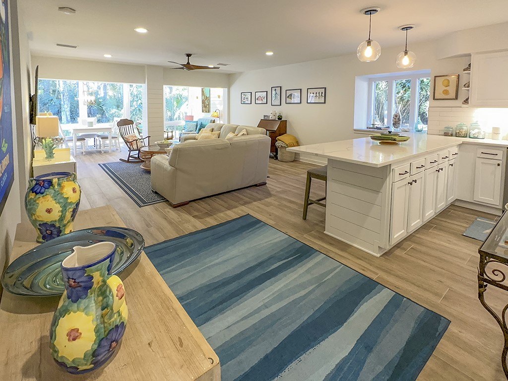 3211 Sea Marsh Road Fernandina Beach, FL 32034 - Photo 4 of 30 a living room with kitchen island furniture and a wooden floor
