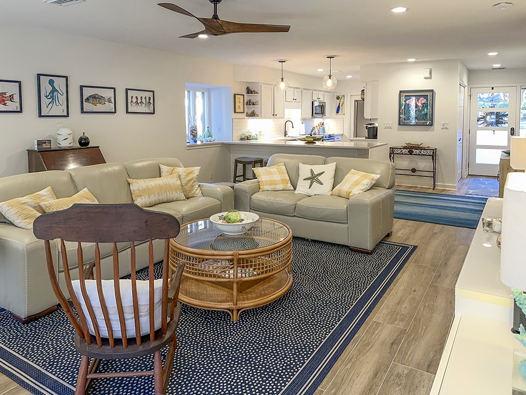 3211 Sea Marsh Road Fernandina Beach, FL 32034 - Photo 6 of 30 a living room with furniture a rug and kitchen view