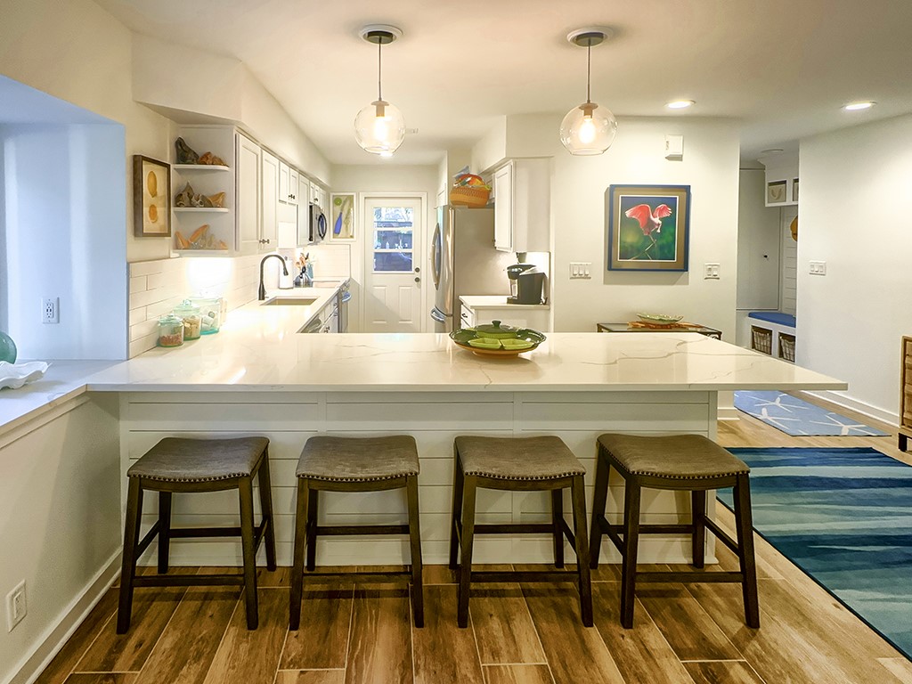 3211 Sea Marsh Road Fernandina Beach, FL 32034 - Photo 7 of 30 a room with dining table and chairs