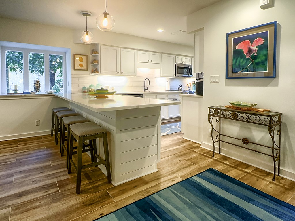 3211 Sea Marsh Road Fernandina Beach, FL 32034 - Photo 8 of 30 a living room with kitchen island granite countertop wooden floor and a fireplace