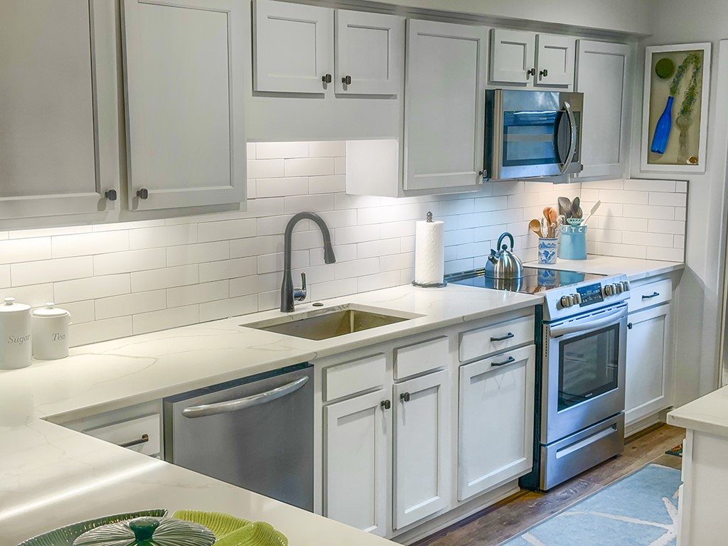 3211 Sea Marsh Road Fernandina Beach, FL 32034 - Photo 9 of 30 a kitchen with cabinets appliances and a sink