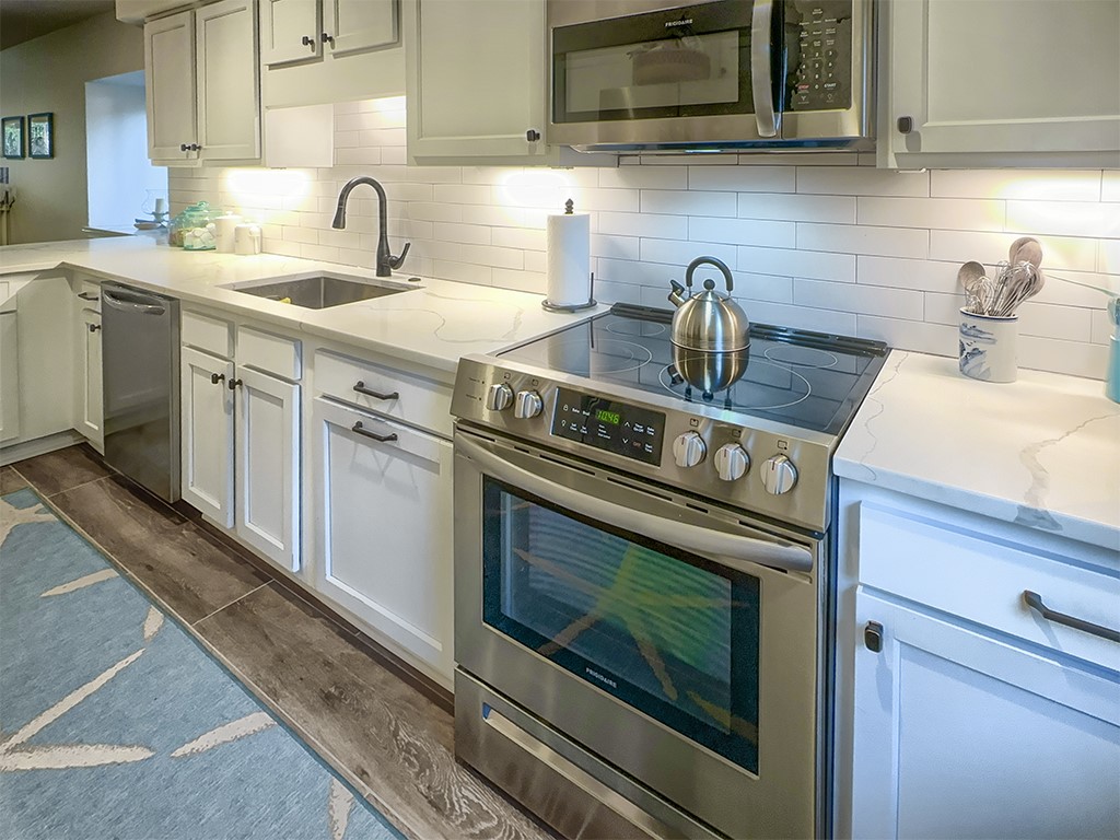 3211 Sea Marsh Road Fernandina Beach, FL 32034 - Photo 10 of 30 a kitchen with a stove and a sink
