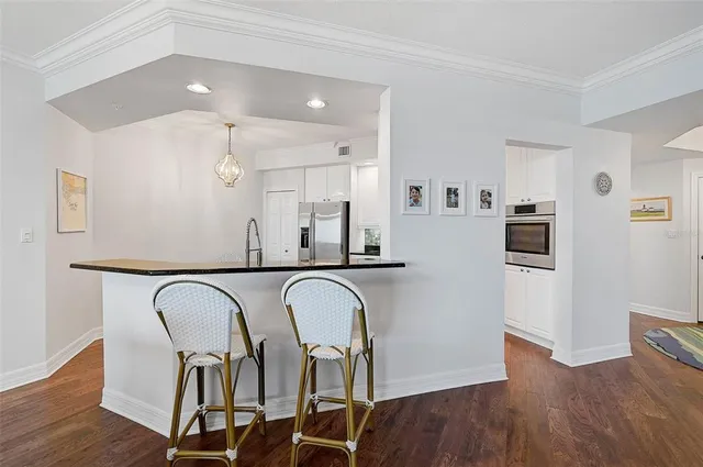 a view of a dining room with furniture wooden floor and chandelier