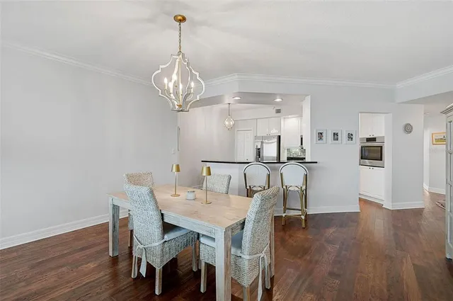 a view of a dining room with furniture wooden floor and chandelier