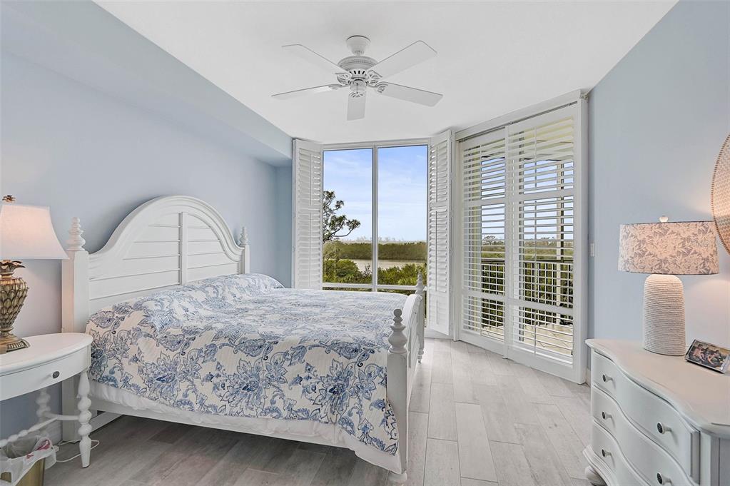 385 North Point Road, Unit 402 Osprey, FL 34229 - Photo 16 of 62 a living room with a bed furniture and a large window