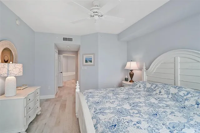 a bathroom with a granite countertop sink a toilet a mirror and shower