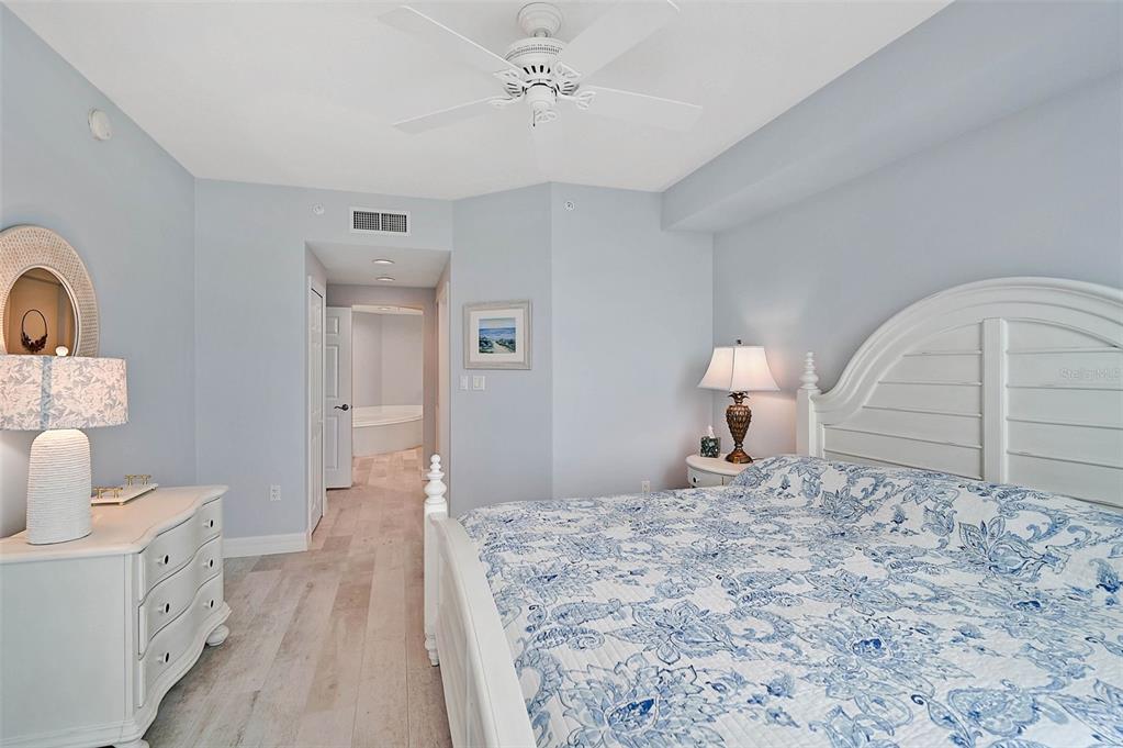 385 North Point Road, Unit 402 Osprey, FL 34229 - Photo 17 of 62 a bedroom with a bed and a lamp on dresser