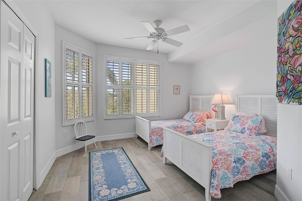 385 North Point Road, Unit 402 Osprey, FL 34229 - Photo 24 of 62 a bedroom with a bed and a window