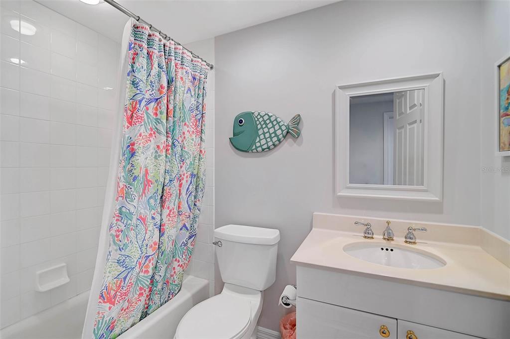 385 North Point Road, Unit 402 Osprey, FL 34229 - Photo 25 of 62 a bathroom with a sink a toilet and a mirror