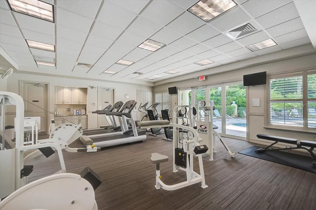 385 North Point Road, Unit 402 Osprey, FL 34229 - Photo 36 of 62 a living room with furniture large window and gym equipment