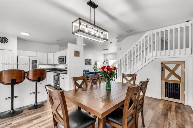 a view of a dining room with furniture and chandelier