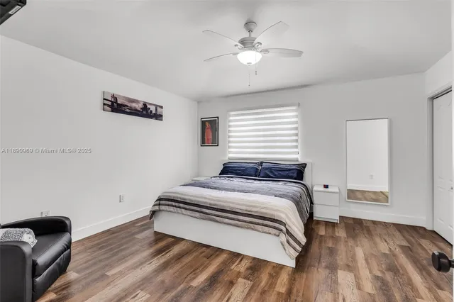 a bedroom with a bed and a ceiling fan