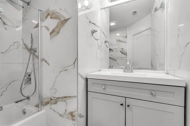a bathroom with a sink double vanity and shower