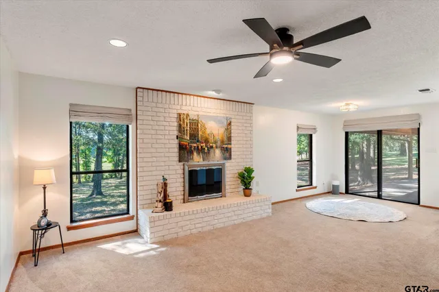 a view of livingroom with furniture fan and window