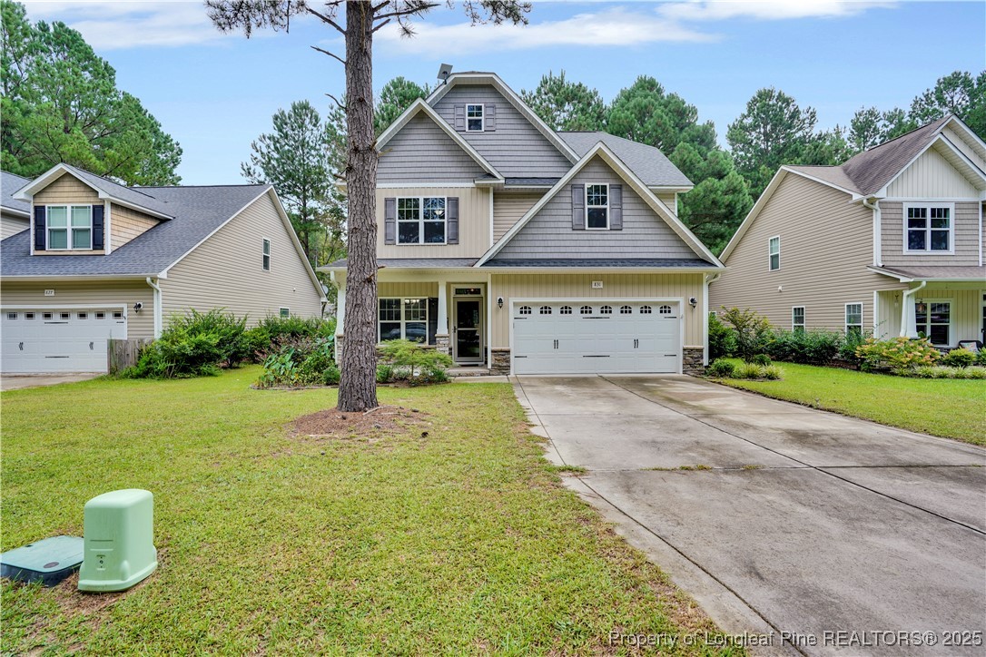a front view of a house with a yard and garage