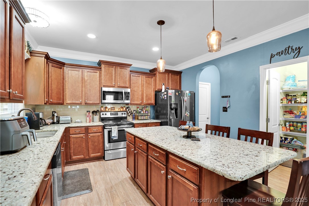 831 Thrush Drive Vass, NC 28394 - Photo 15 of 35 a kitchen with stainless steel appliances granite countertop a sink dishwasher stove refrigerator and cabinets