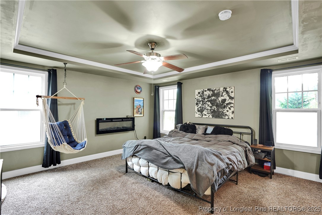 831 Thrush Drive Vass, NC 28394 - Photo 19 of 35 a bedroom with a bed and a chandelier