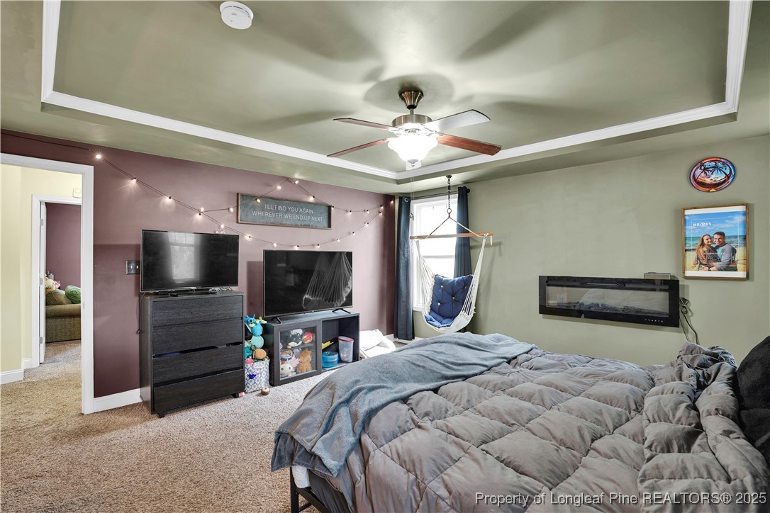 831 Thrush Drive Vass, NC 28394 - Photo 20 of 35 a bedroom with a bed and a flat screen tv