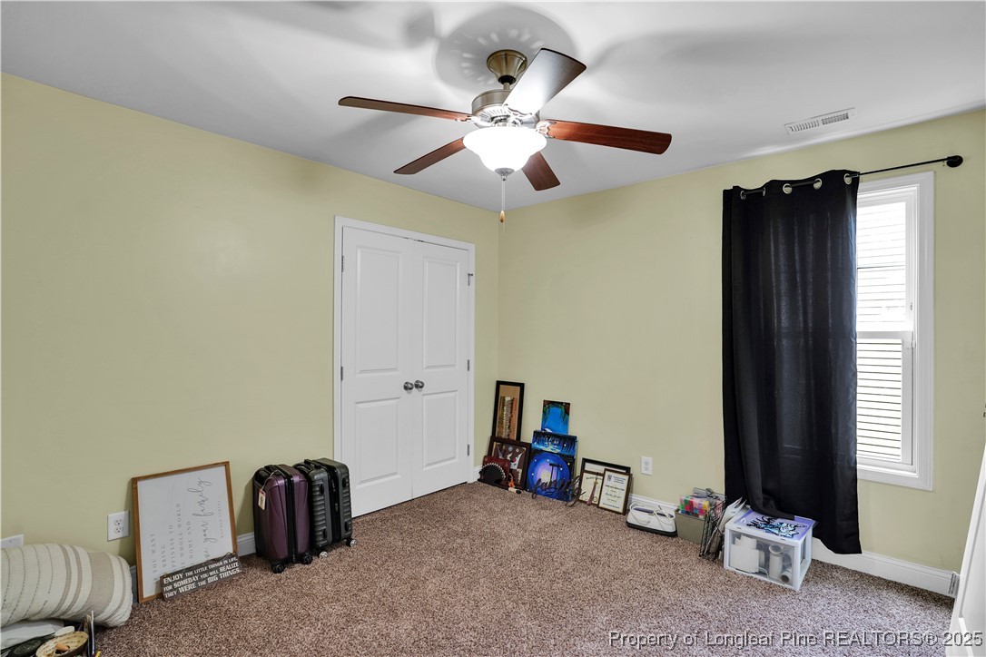831 Thrush Drive Vass, NC 28394 - Photo 27 of 35 a living room with furniture and a window