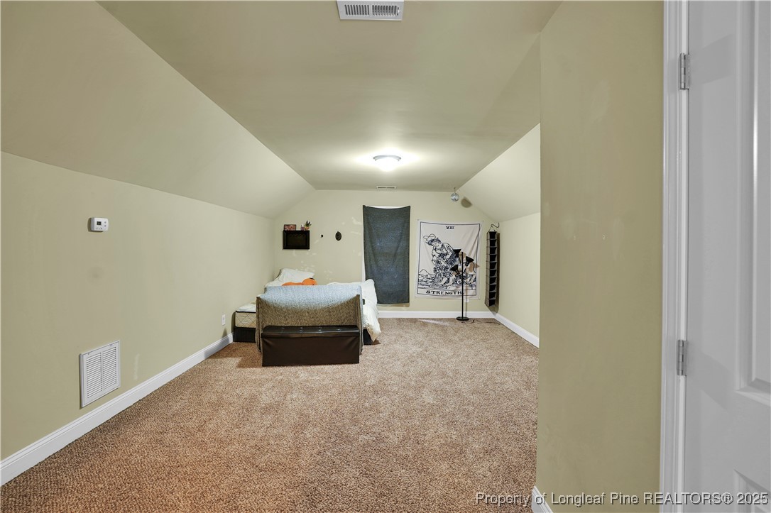 831 Thrush Drive Vass, NC 28394 - Photo 30 of 35 a bedroom with a bed and a couch