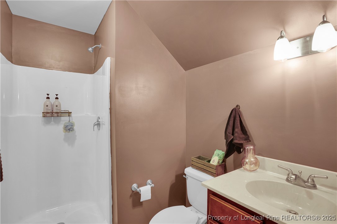 831 Thrush Drive Vass, NC 28394 - Photo 32 of 35 a bathroom with a sink toilet and mirror