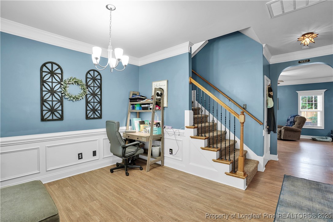 831 Thrush Drive Vass, NC 28394 - Photo 5 of 35 a view of a livingroom with wooden floor and staircase
