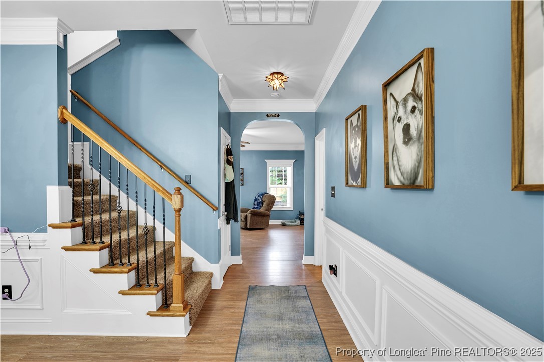 831 Thrush Drive Vass, NC 28394 - Photo 6 of 35 a view of a hallway with wooden floor and staircase
