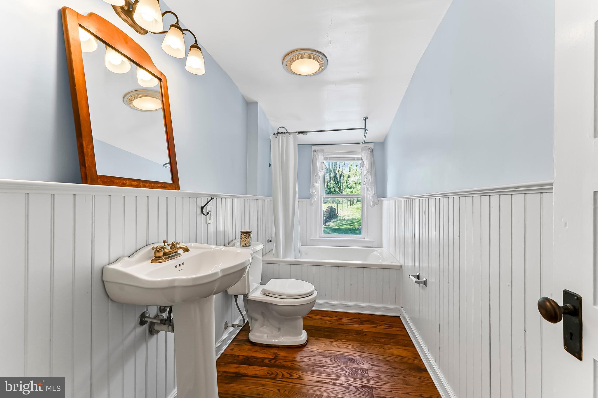 3058 Bailey Crossroads Road Atglen, PA 19310 - Photo 18 of 41 a bathroom with a sink a toilet and mirror