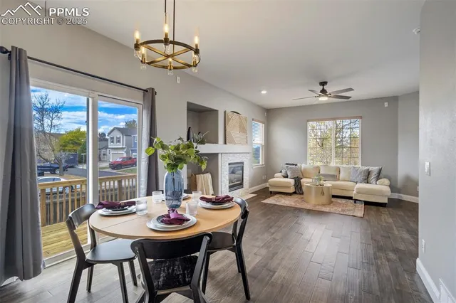 a view of a dining room with furniture wooden floor and chandelier
