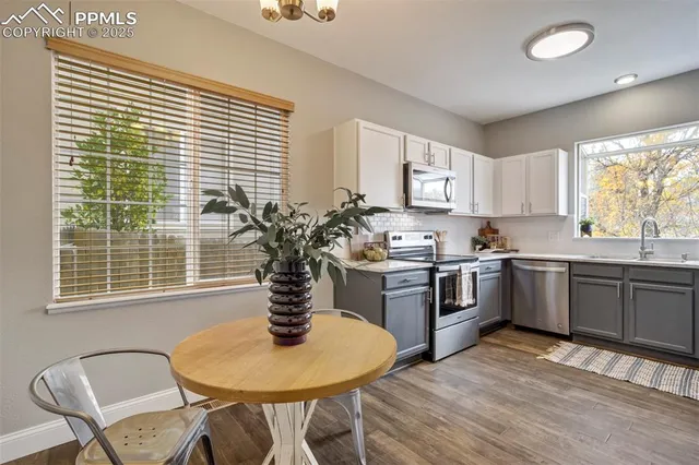 a kitchen with a table chairs stove and cabinets